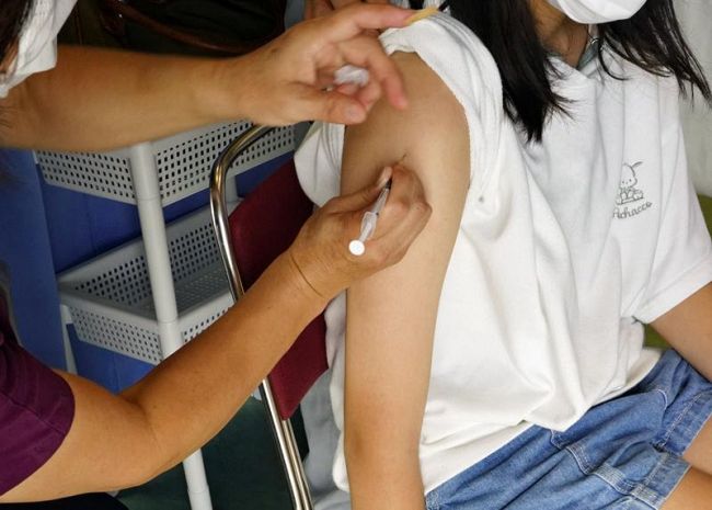 新型コロナウイルスワクチン接種を受ける女子児童（大月町の町農村環境改善センター）