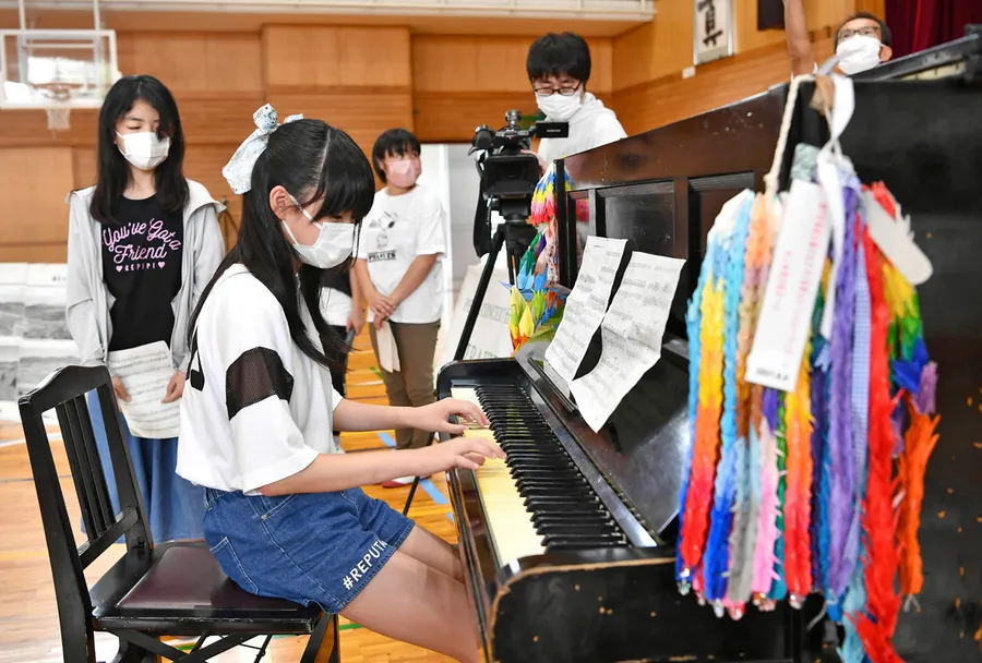 被爆ピアノを演奏する児童（高知市横内の横内小）